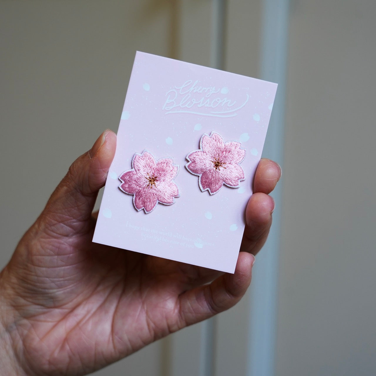 sakura cherry blossom stick-on patch held in hand
