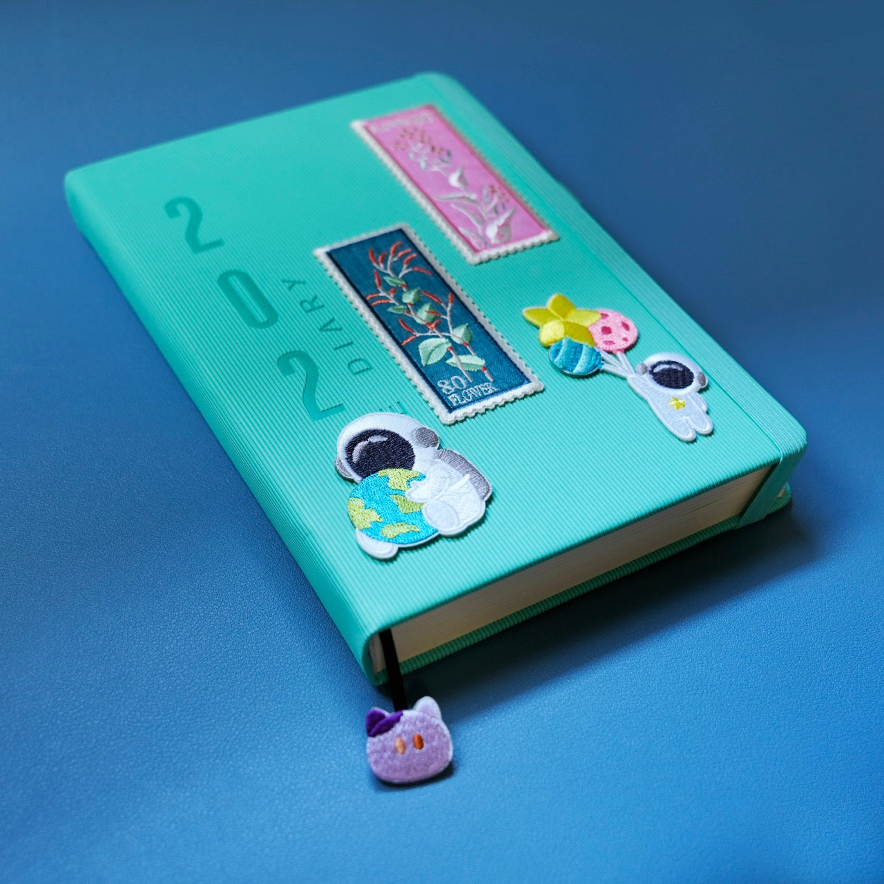 kawaii astronaut embroidered patch on a notebook cover