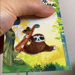 animated hand holding packaged cute animal kingdom embroidered patches showing four styles and detailed embroidery texture