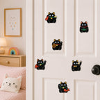black maneki neko cat holding red carp gold coin and lucky charm in various sizes stick-on patches displayed on a white bedroom door