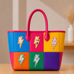 five ditsy floral lightning bolt embroidered patches on a bold color-block leather tote bag