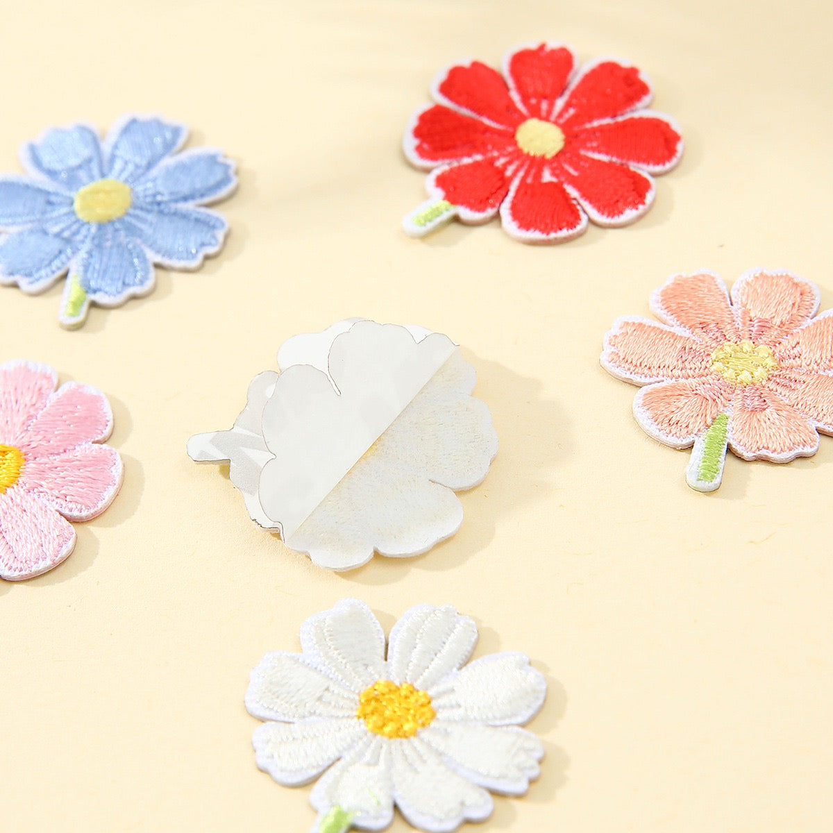 peel-and-stick backing of cosmos flower embroidered patch