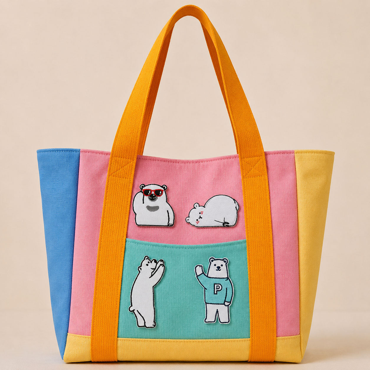 four polar bear embroidered patches on a color-block canvas tote bag