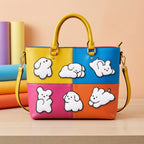 fluffy white puppy embroidered stick-on patches on a colorful color-block leather tote bag