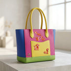 five woodland squirrel embroidered patches on a color-block leather tote bag