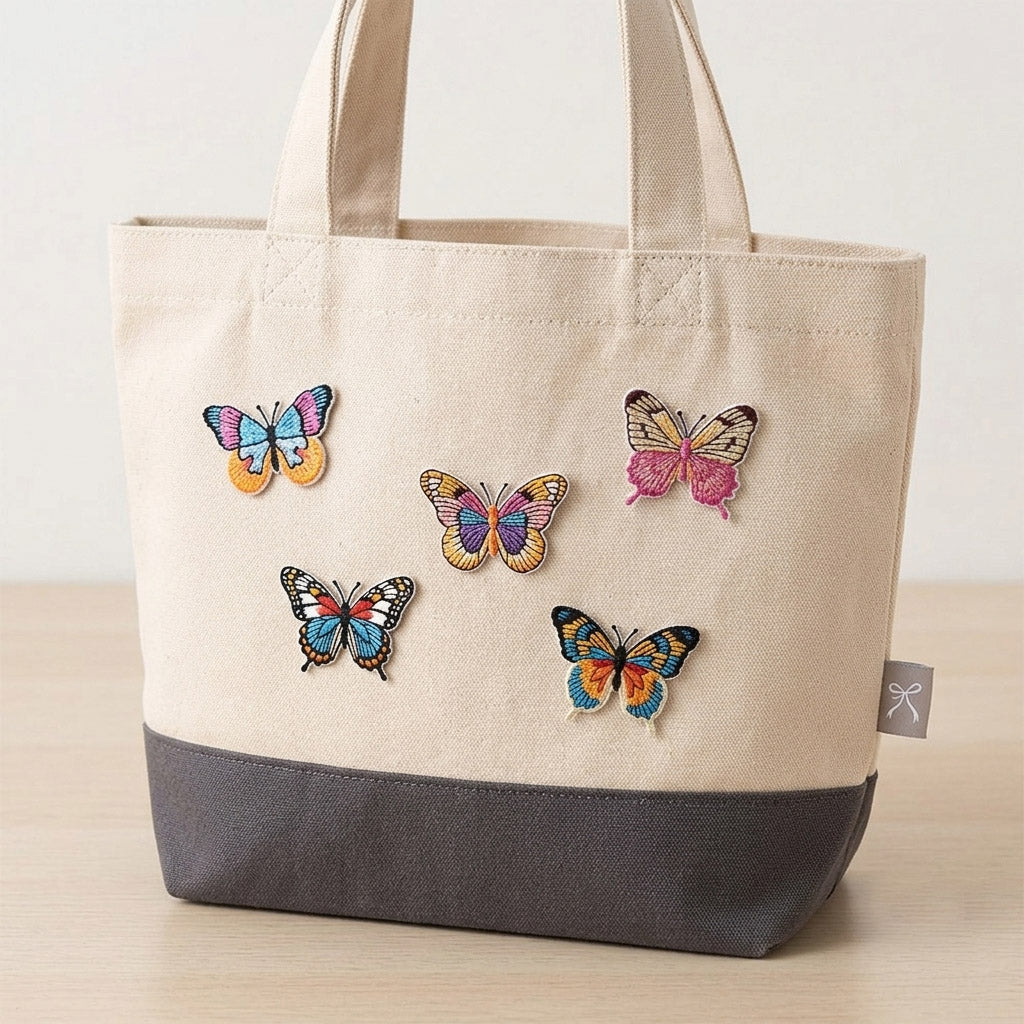 colorful monarch butterfly embroidered stick-on patch on a canvas tote bag