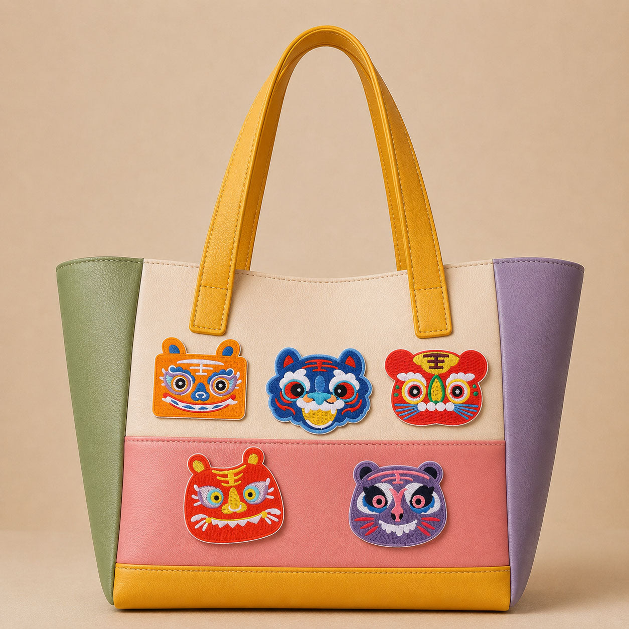 lucky zodiac tiger face stick-on patches in traditional folk style decorating a soft color-block leather handbag