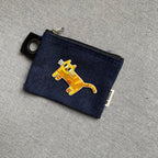 derpy orange cat embroidered patch on a dark denim coin pouch