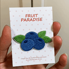 animated hand holding packaged juicy fruit embroidered patches showing six styles and detailed embroidery texture
