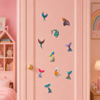 colorful mermaid tail stick-on patches with rainbow gradient curled fin wave splash and heart detail in ten styles on a pink door in a girls room