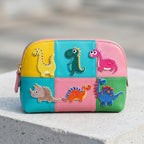 six colorful dinosaur embroidered patches on a colorblock leather cosmetic pouch