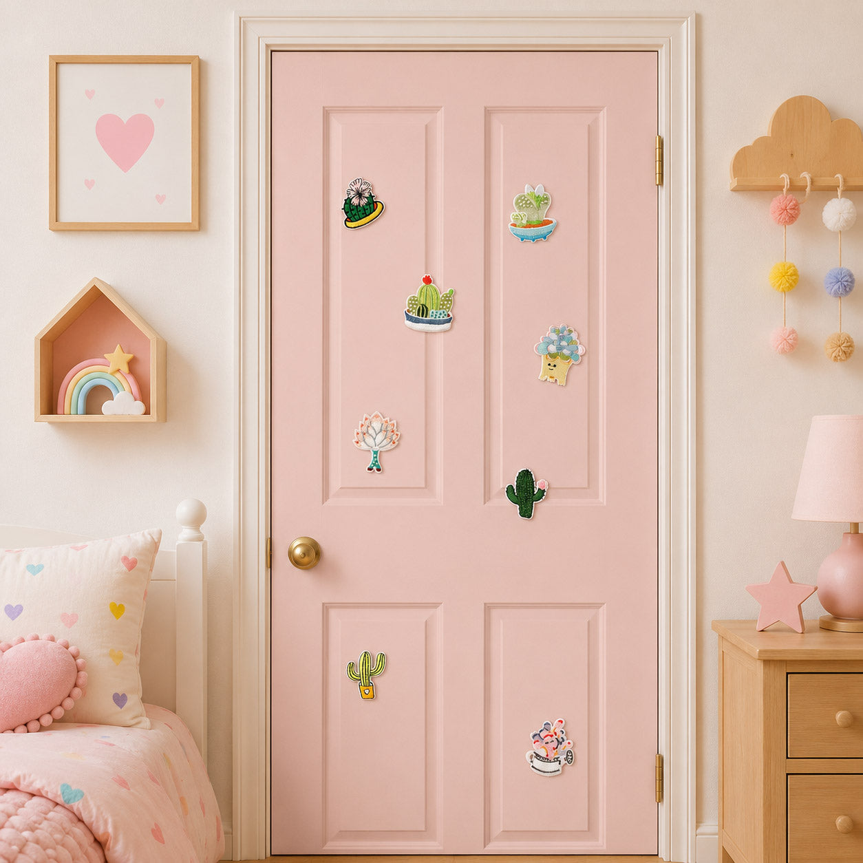 kawaii cactus and succulent in teacup blue pot and white planter with bunny ear and smiley face stick-on patches on a pink door in a girls room