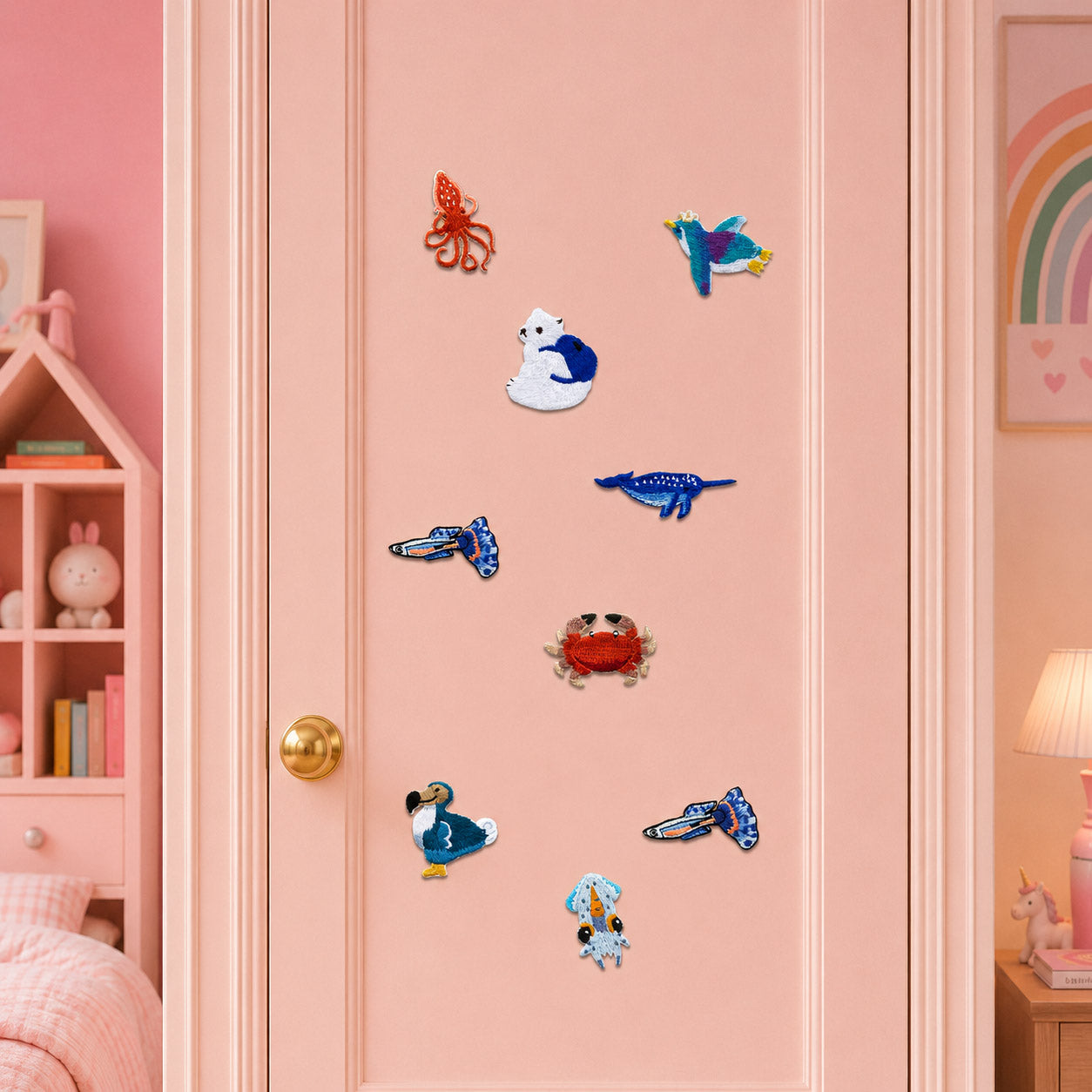 red octopus blue whale sunglasses crab flying fish transparent squid polar bear with earth and seabird stick-on patches on a pink closet door in a girls room