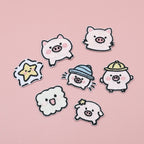 Seven embroidered stick-on patches featuring five pink piglets, a yellow star, and a smiling cloud
