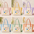 cute paper airplane embroidered stick-on patches styled on six pastel tote bags — pink yellow purple blue mint and orange bags each decorated with a full set of six paper airplane patches