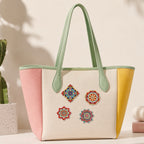 Vintage floral mandala embroidered stick-on patches decorating a tote bag
