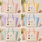 cute heart stocking embroidered stick-on patches styled on six pastel tote bags — full set of nine colour stockings arranged in grid formation on pink yellow lavender blue mint and orange bags