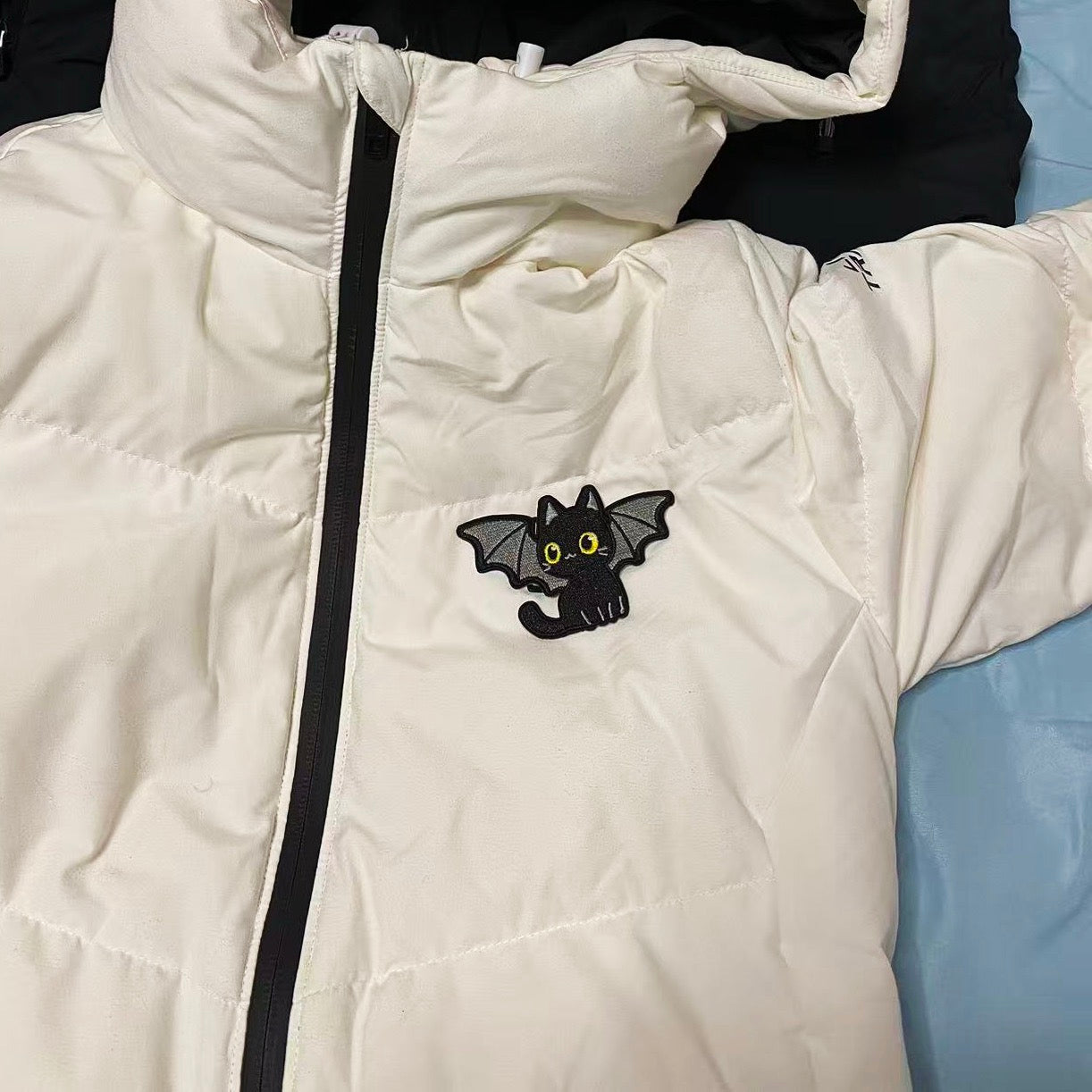 Halloween black cat embroidered patch on a puffer jacket