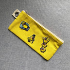 quirky duck embroidered patches on a yellow canvas pencil case