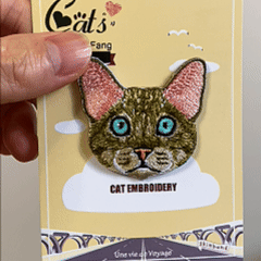 animated hand holding packaged famous cat breeds embroidered patches showing seven styles and detailed embroidery texture