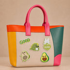avocado dinosaur bunny and good vibes stick-on patches decorating a pink and orange color-block leather handbag