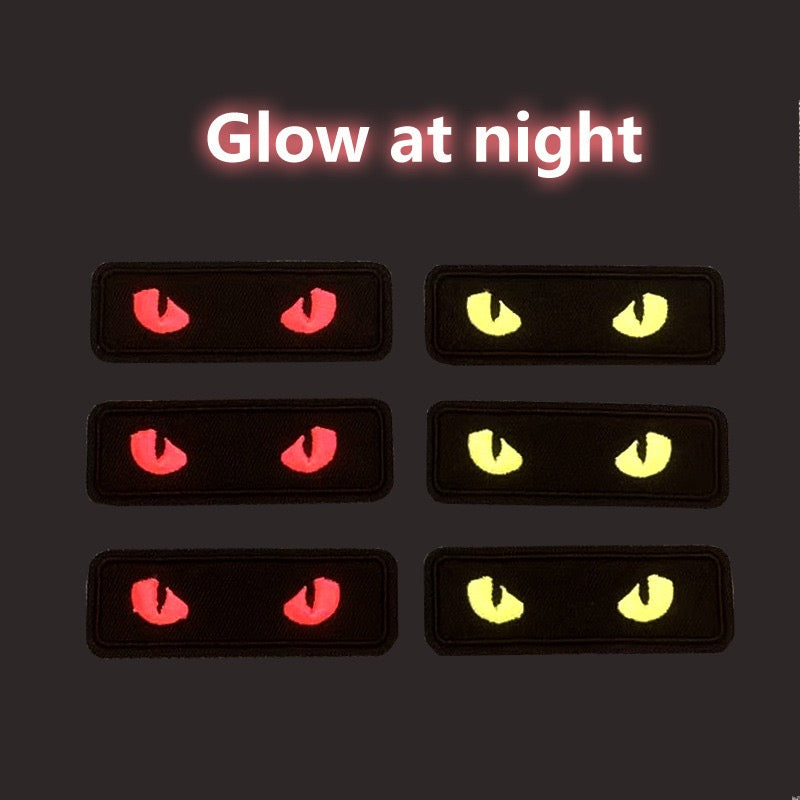 glow-in-the-dark cat eye embroidered patch glowing in the dark — yellow and red cat eyes