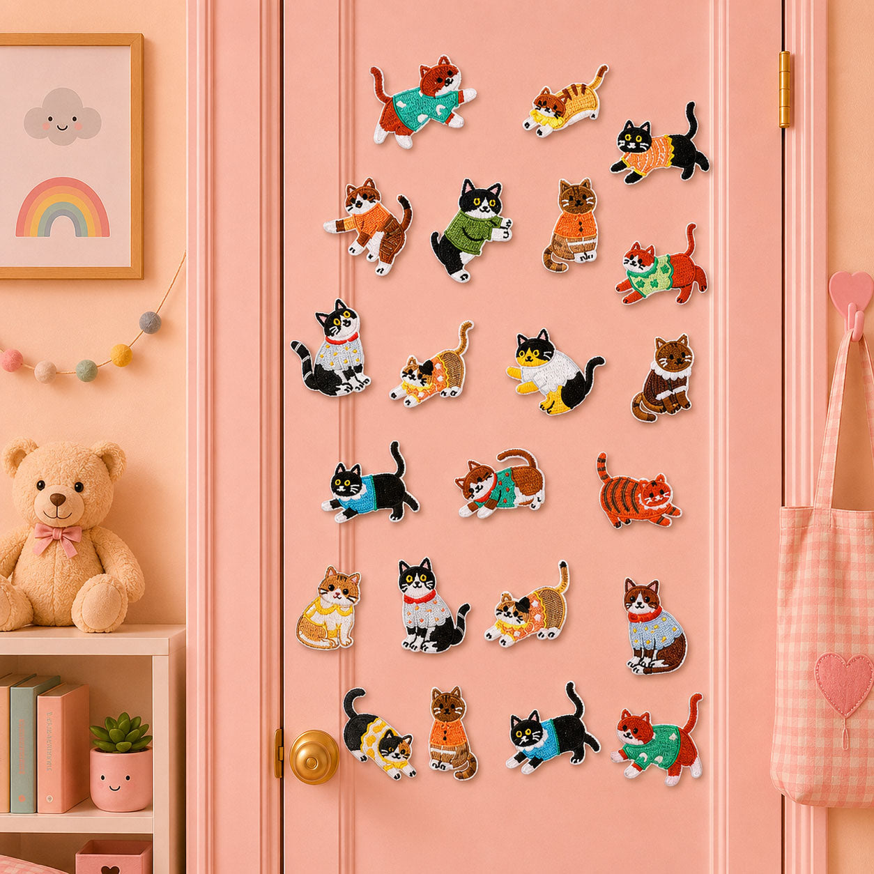 tabby tuxedo calico and black cats in green orange blue red and yellow knit sweaters and white lace collar stick-on patches densely arranged on a pink door