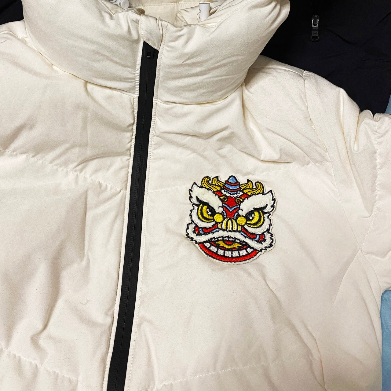 chinese fortune lion dance embroidered stick-on patch on a down jacket