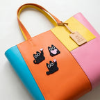 black cat holding heart cat hugging heart and cat with flower embroidered patches on a color-block bag