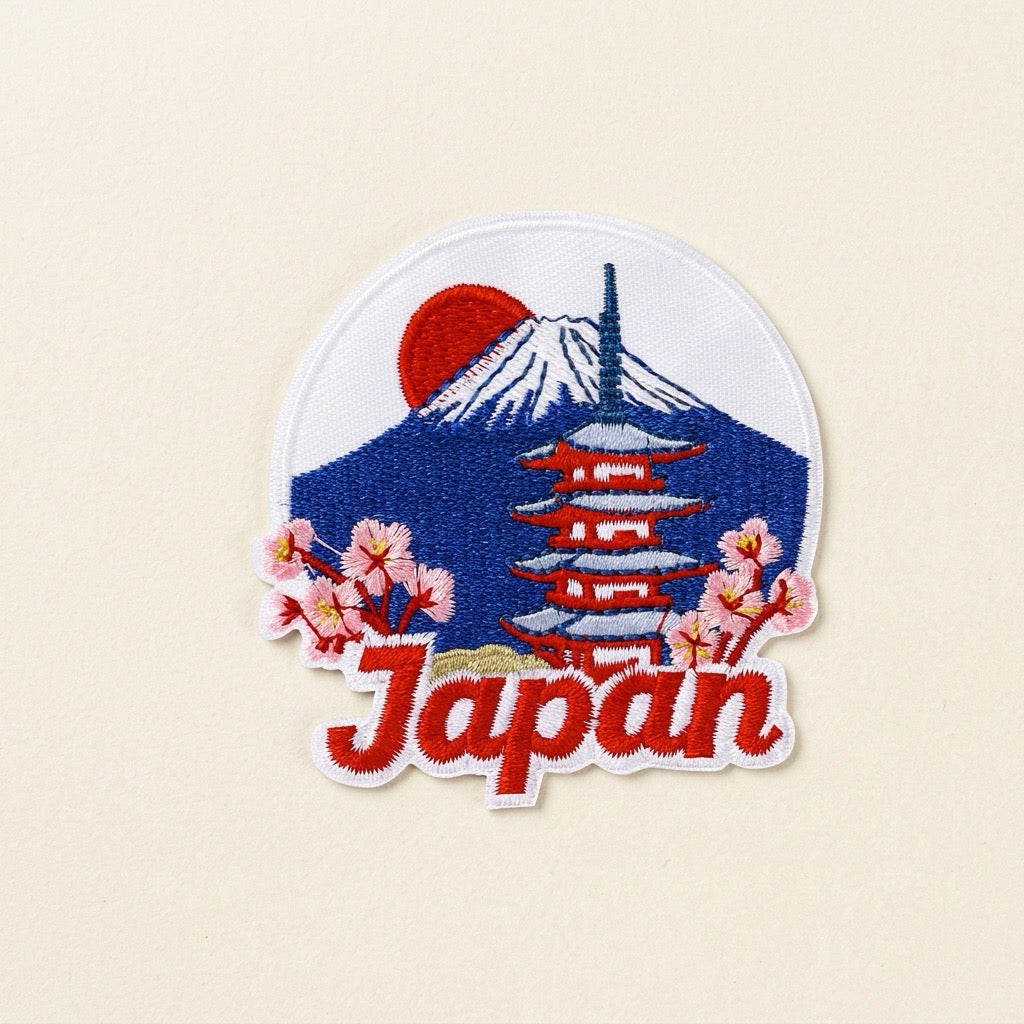 Japan embroidered patch with Mount Fuji, a red pagoda, and cherry blossoms on an ivory background
