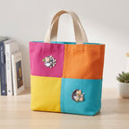 happy hedgehog embroidered stick-on patches on a colorful color-block canvas tote bag