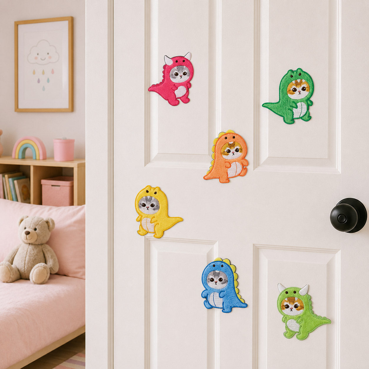 six purr-saurus cat in dinosaur costume embroidered patches stuck on a white door in a pink kids room