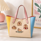 relaxing capybara in hot spring and on crocodile stick-on patches decorating a yellow and blue color-block leather handbag