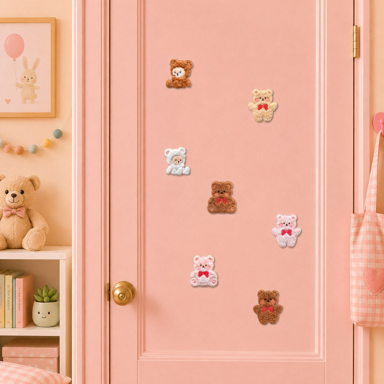 curly bouclé texture teddy bear in bear ear hood holding red bow and heart in seven sizes and colors stick-on patches on a pink door in a pastel room