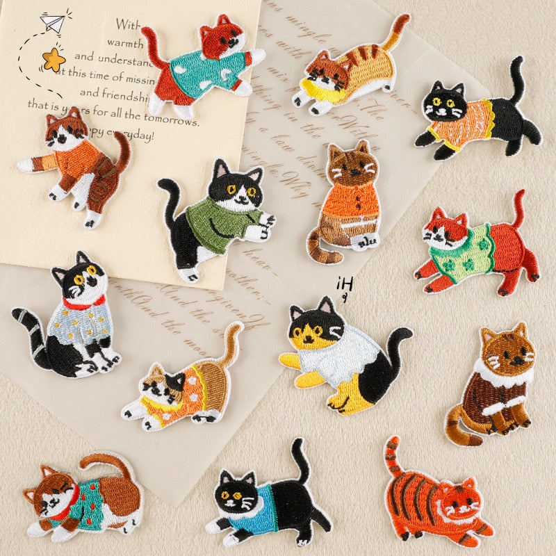 set of fourteen whimsical cat apparel embroidered stick-on patches
