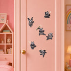 gray raccoon in kung fu action poses holding green weapon single leg kick jumping and clasping hands with motion lines stick-on patches on a pink door in a girls room