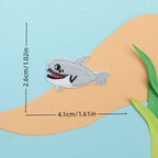 grey shark embroidered stick-on patch — grinning cartoon shark with teeth
