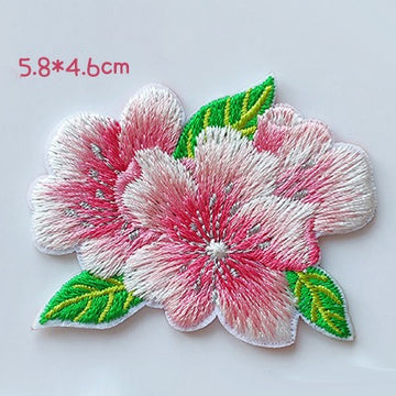 Twin cherry blossoms with green leaves embroidered patch measuring approximately 58 by 46 mm

