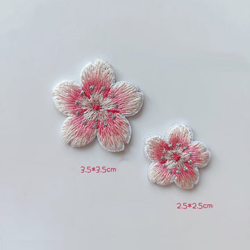 Large and small soft pink-and-white cherry blossom patches with silver-tone stitched stamens
