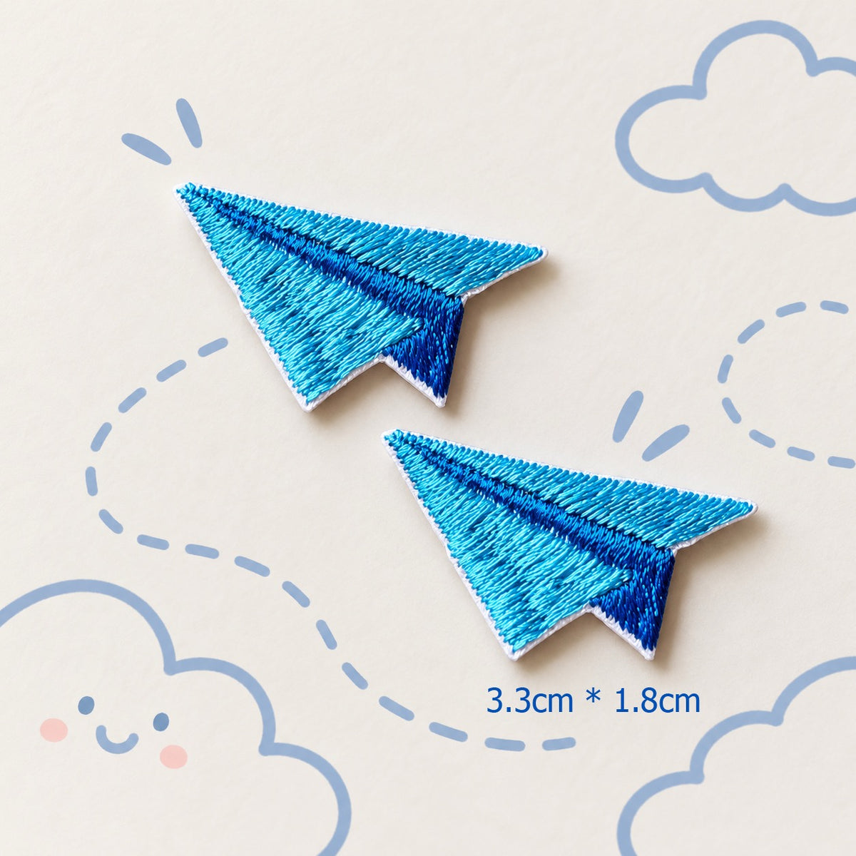 blue paper airplane embroidered stick-on patches — pair of bright blue satin embroidery paper planes with deep blue fold crease detail 33x18mm