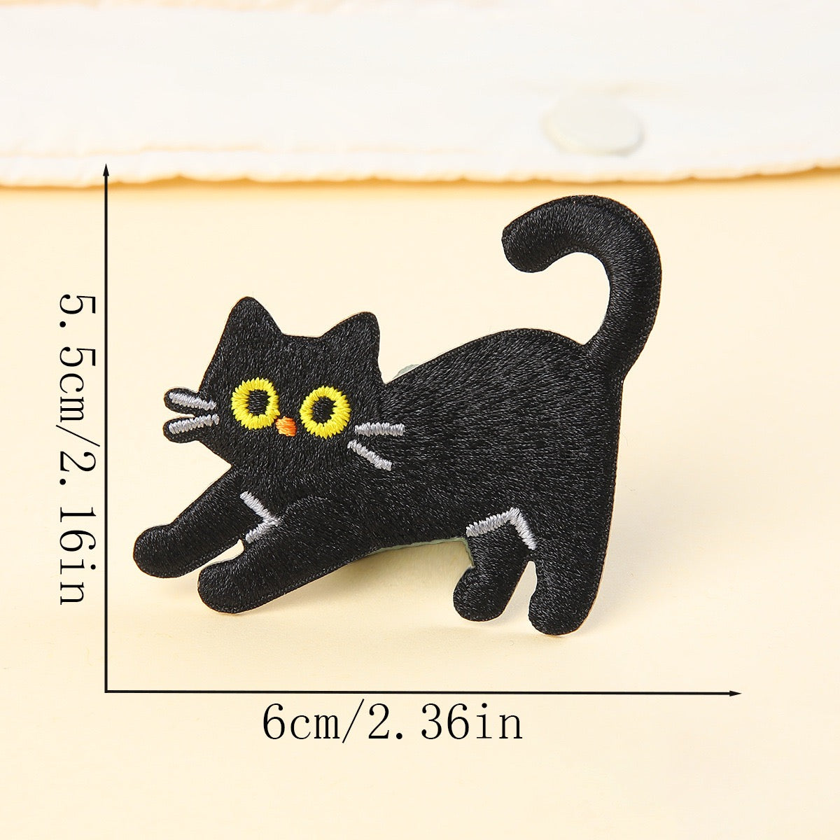 stretching black cat embroidered stick-on patch — front paws extended tail up