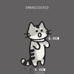 Angry gray tabby cat embroidered stick-on patch with open mouth and curled tail
