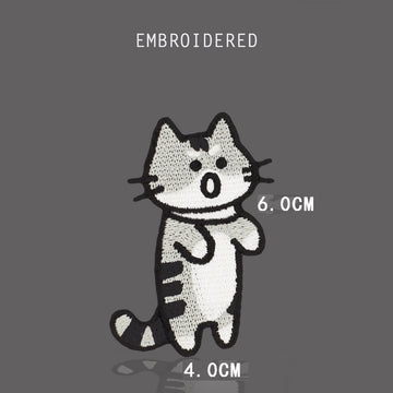 Angry gray tabby cat embroidered stick-on patch with open mouth and curled tail
