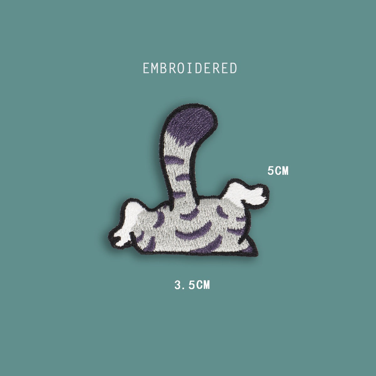 cat tail and legs embroidered stick-on patch — grey tabby back half with striped body curved tail and dangling white paws going over an edge