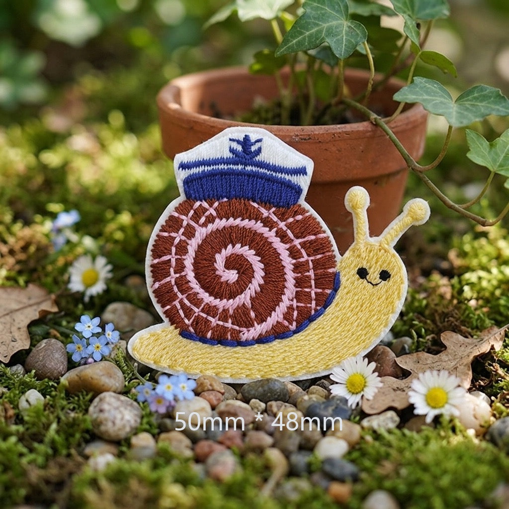 yellow snail with brown woven shell and blue sailor hat cottagecore embroidered stick-on patch