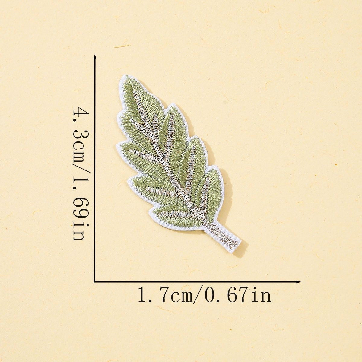 green leaf embroidered stick-on patch with silver metallic vein detail