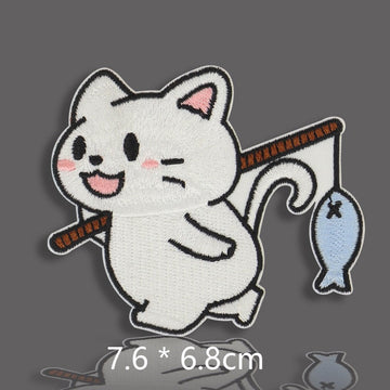 white cat holding fishing rod with small blue fish embroidered stick-on patch