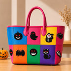 cute spooky halloween stick-on patches with ghost pumpkin and bat on a vibrant color-block leather handbag