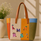 cute bear bunny frog and rabbit letter patches L M N R S T with umbrella star and fruit decorating a bold multicolor leather handbag