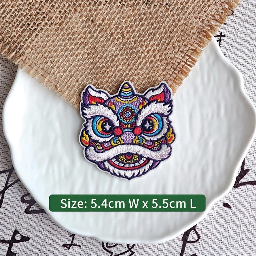 purple and yellow Chinese lion dance embroidered stick-on patch — blue purple forehead with turquoise multicolor accents round yellow eyes full white fur border largest of the four